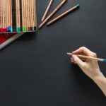 person holding brown pencil
