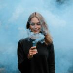 shallow focus photography of woman surrounded by smoke