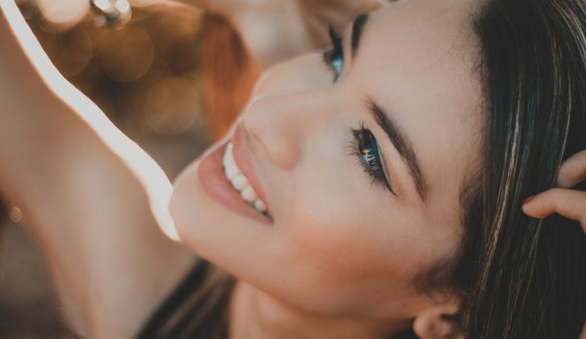 smiling woman with black hair and red lipstick