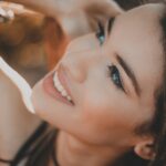 smiling woman with black hair and red lipstick